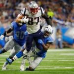Rob Gronkowski tries to shed tacklers against the Lions.