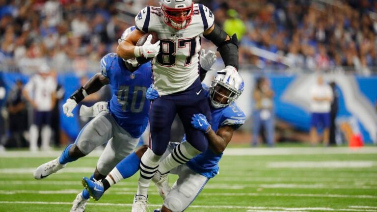 Rob Gronkowski tries to shed tacklers against the Lions.
