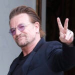 U2 singer Bono makes a peace sign as he arrives for a meeting in Paris.