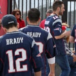 A group of Patriots fans wearing Tom Brady jerseys.