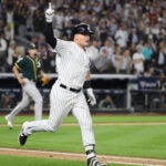 The New York Yankees' Luke Voit hits a triple in the sixth inning of their American League wild-card game against Oakland, at Yankee Stadium in the Bronx.