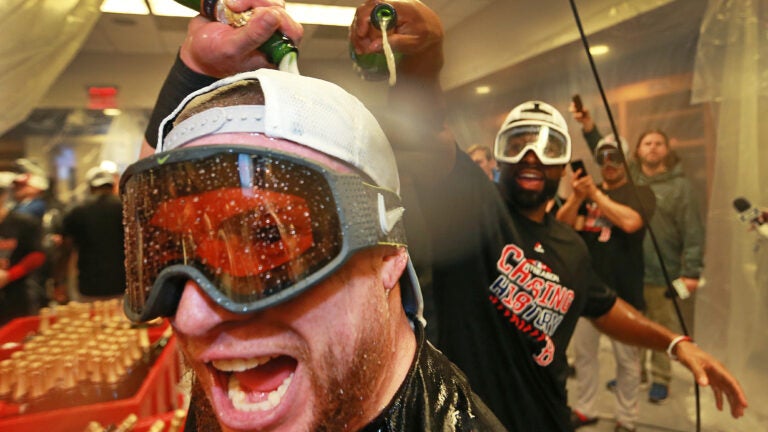 Boston Red Sox's Mookie Betts laughs after being doused with