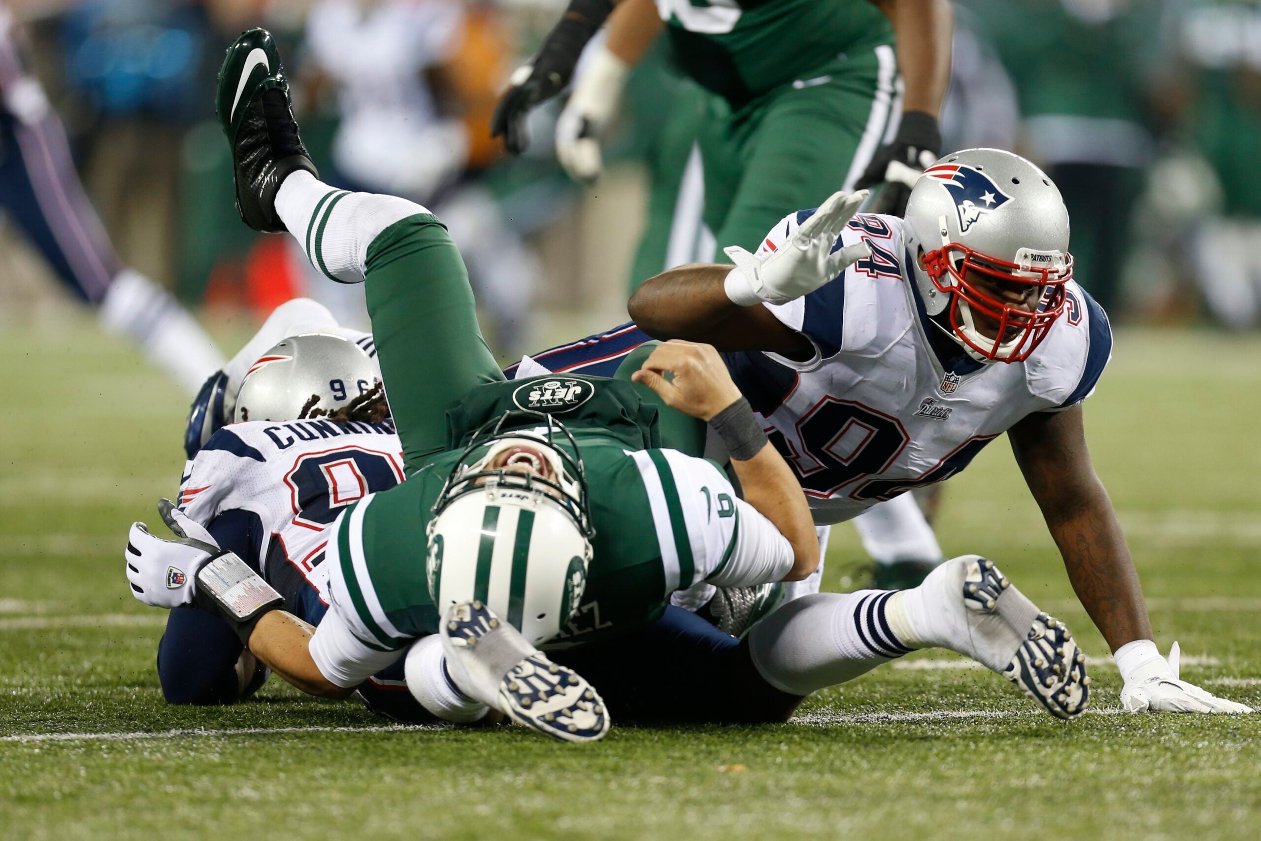 New York Jets quarterback Mark Sanchez rolls out of the pocket in