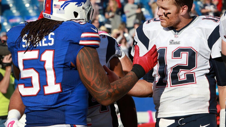 Pro bowl quarterback Tom Brady of the AFC watches the action from