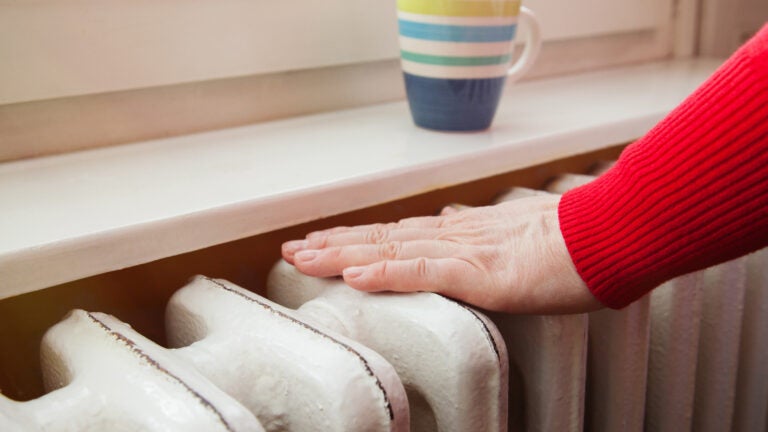 Hand-Checks-Radiator-Home-Heating