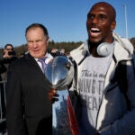 Jason McCourty and BIll Belichick with the Super Bowl trophy.