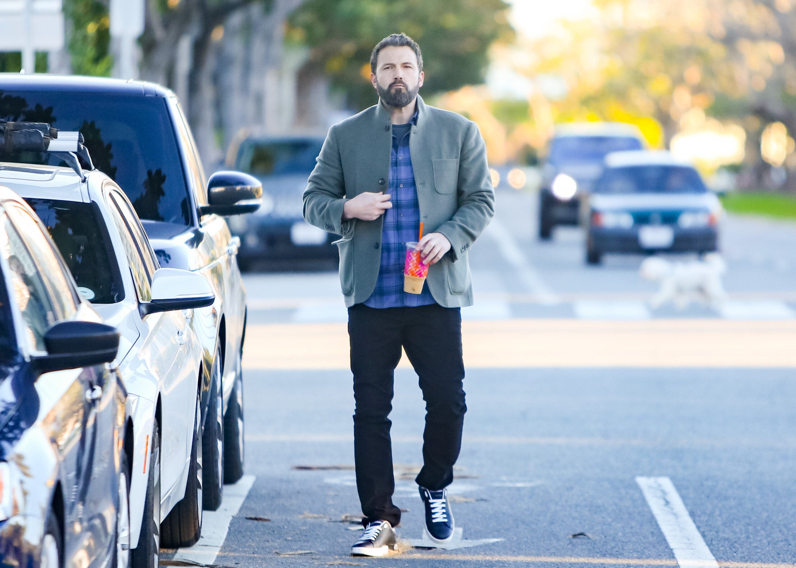 Ben Affleck holding a drink from Dunkin' Donuts.