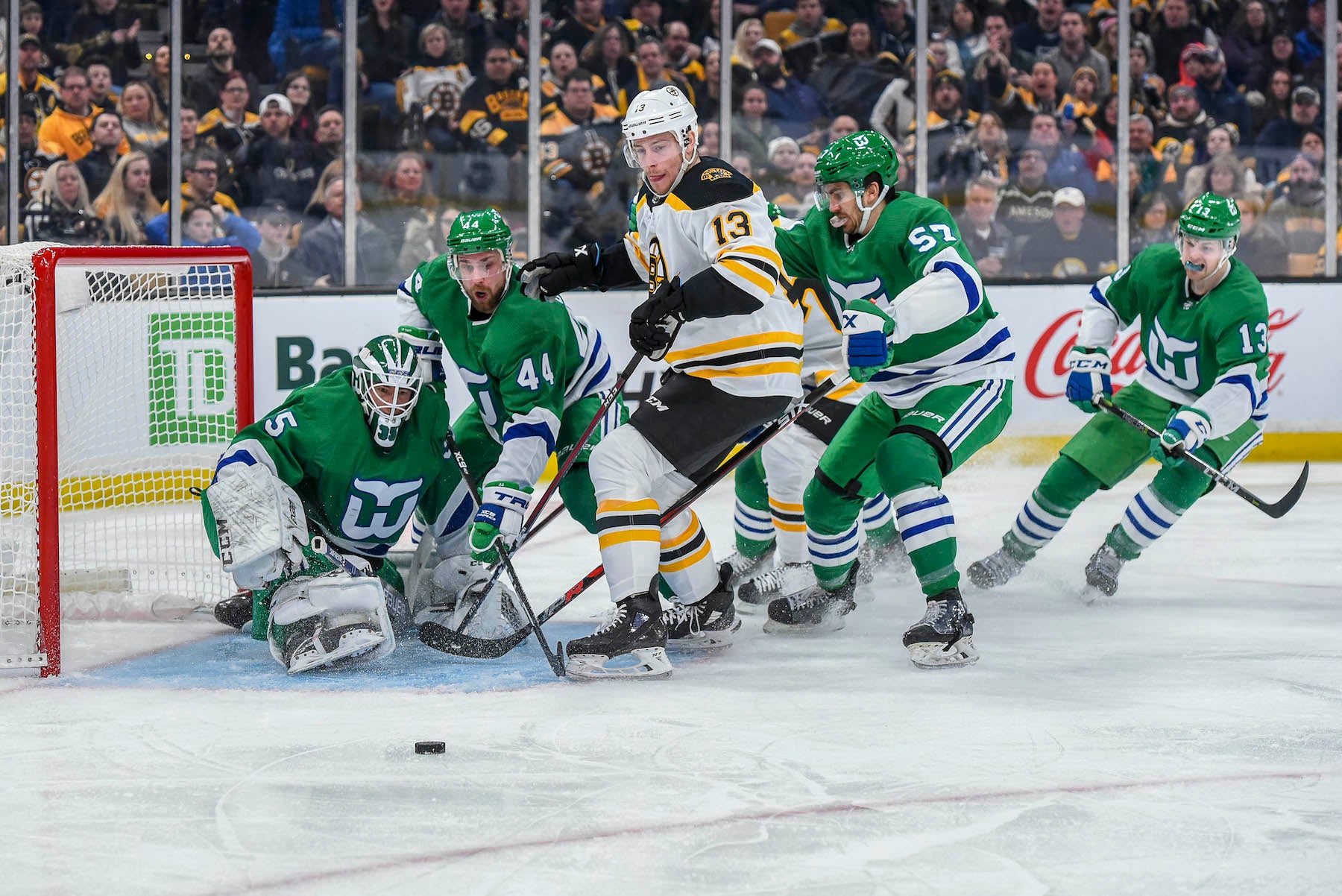 Carolina Hurricanes, in Whalers green, fight past Bruins 5-3