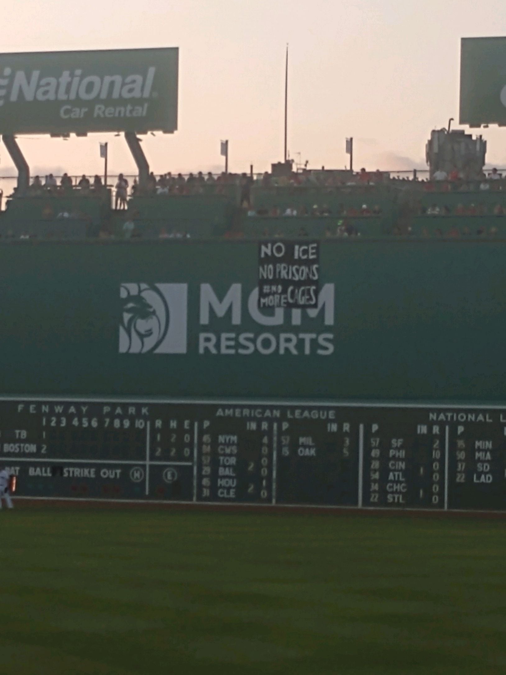 Protestors unfurl 'No ICE, No prisons, No More Cages' banner over Green  Monster at Fenway Park 