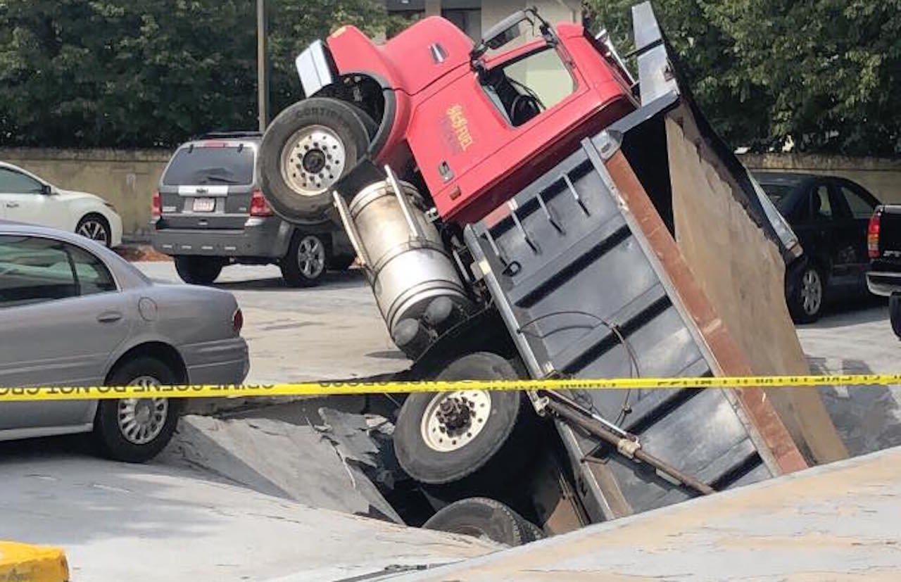Dump truck falls through roof of Quincy parking garage
