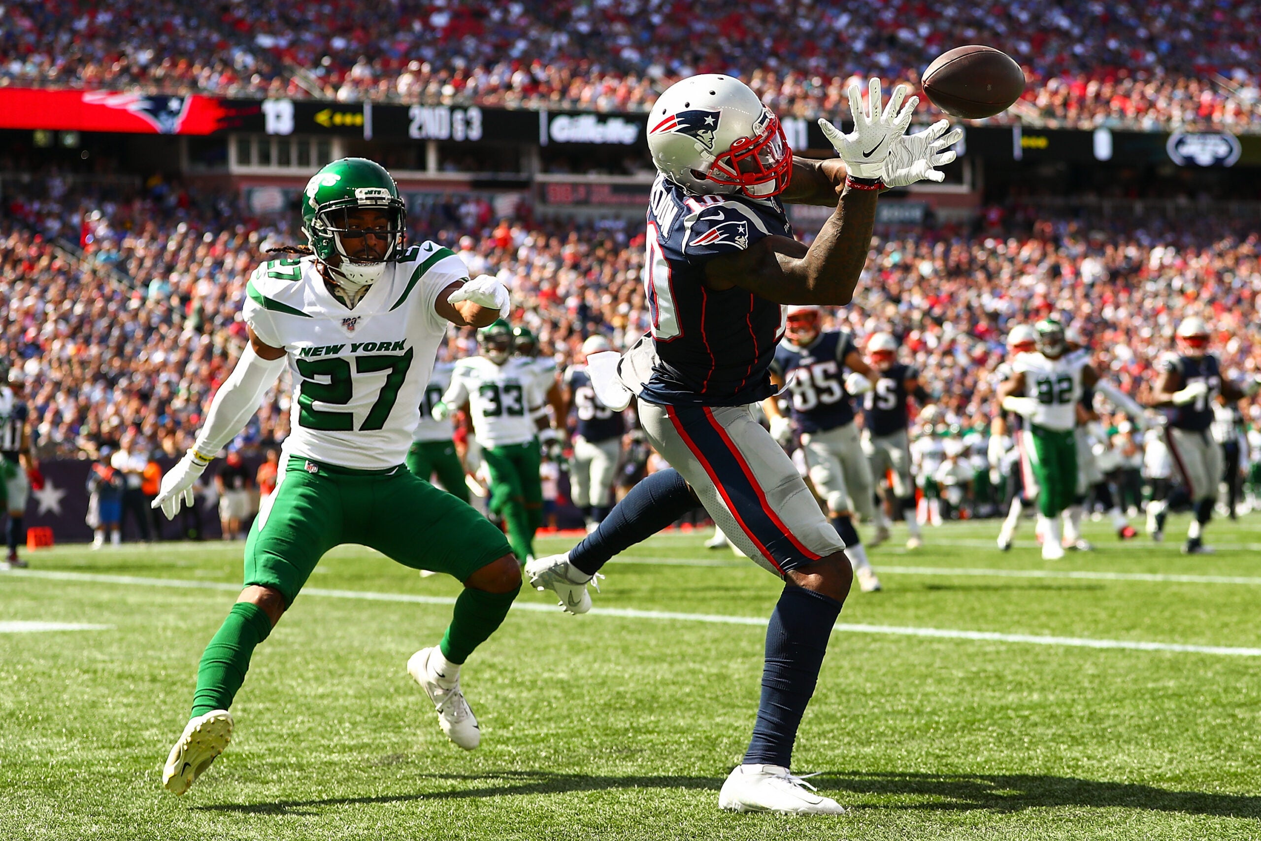 New England Patriots wide receiver Julian Edelman (11) carries back a punt  return for a 30 yard gain in the first quarter against the New York Jets in  week 12 of the