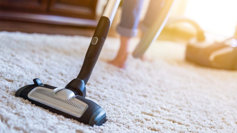 Woman-Using-Vacuum-Adobe-Stock