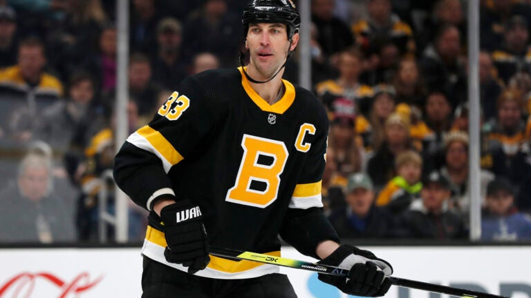 Boston Bruins defenseman Zdeno Chara (33) kisses the helmet of Boston  Bruins left wing Brad Marchand (63) after the Bruins beat the Carolina  Hurricanes 4-3 during extra time of an NHL hockey