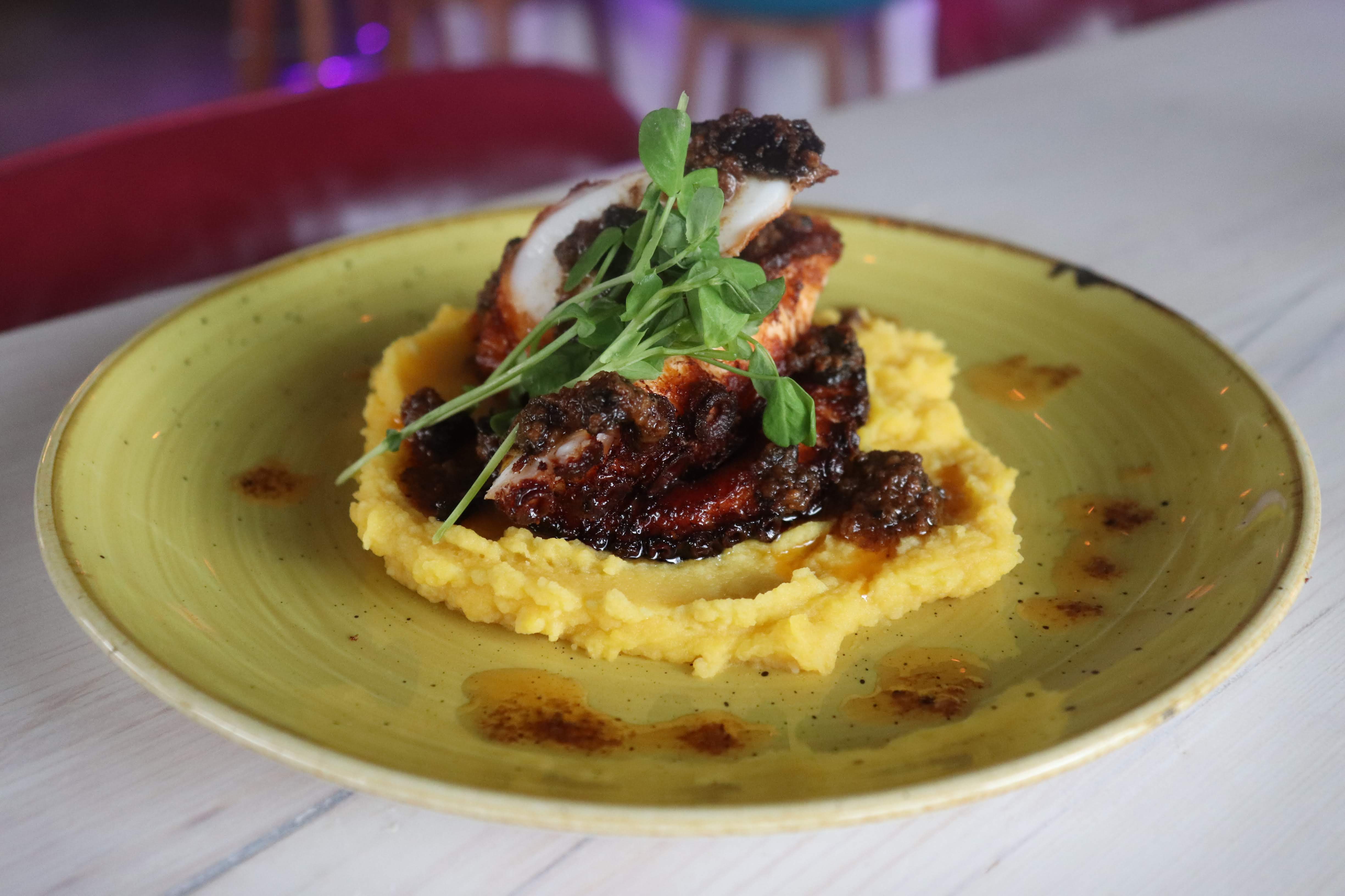 El Ocho octopus tentacle on gold potato purée, drizzled with sauce