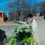 Rev. Timothy Pelc sprays holy water from a squirt gun.