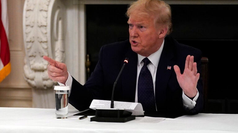 President Donald Trump talks to reporters.