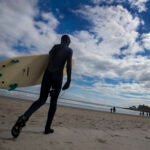 A surfer on Narragansett Beach.