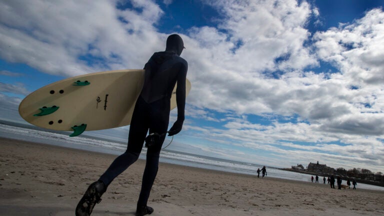 A surfer on Narragansett Beach.