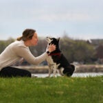 A woman and dog n Carson Beach.