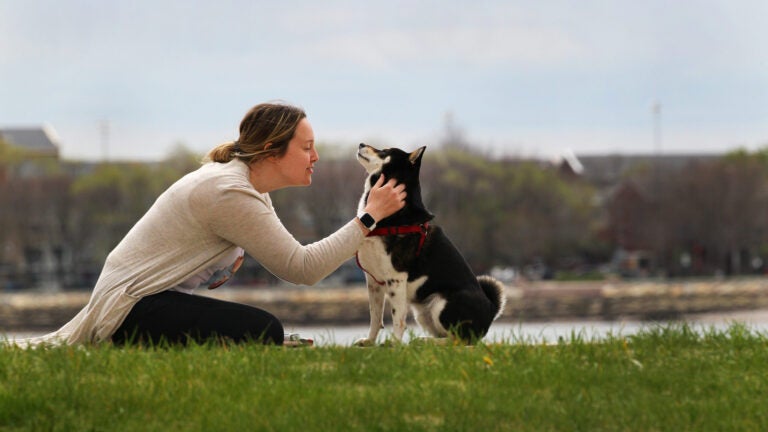 A woman and dog n Carson Beach.