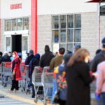 Customers waiting to enter a Costco store.