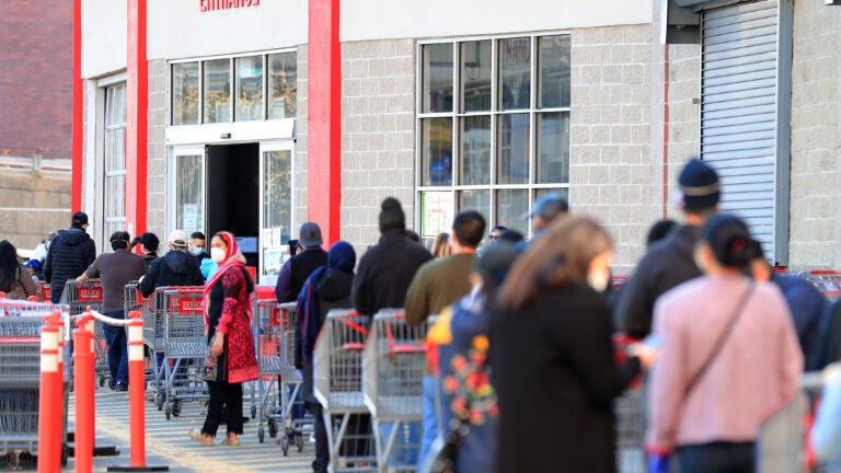 Customers waiting to enter a Costco store.