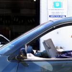 A man waits to get an inspection sticker.