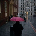 A man passes the Old State House.