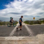 Joggers and bicyclists at Nahant Beach.