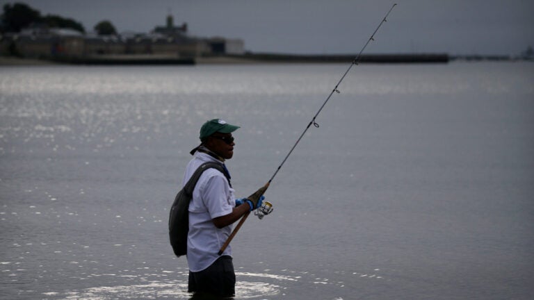 A man fishing off Carson Beach.