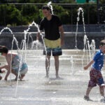 A family relaxes at a Boston fountain.