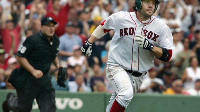 Boston Red Sox second baseman Mark Bellhorn walks in the rain past