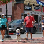 People walk in downtown Plymouth.