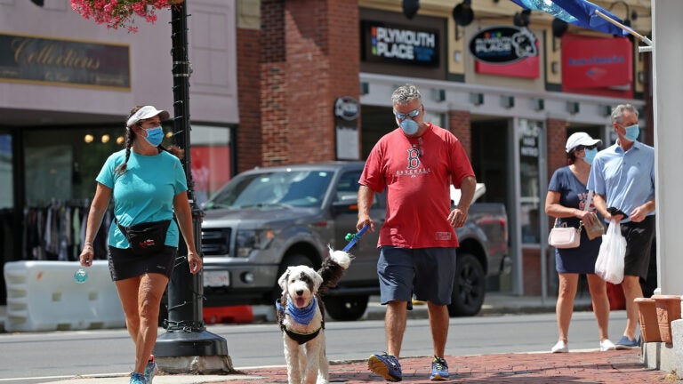 People walk in downtown Plymouth.