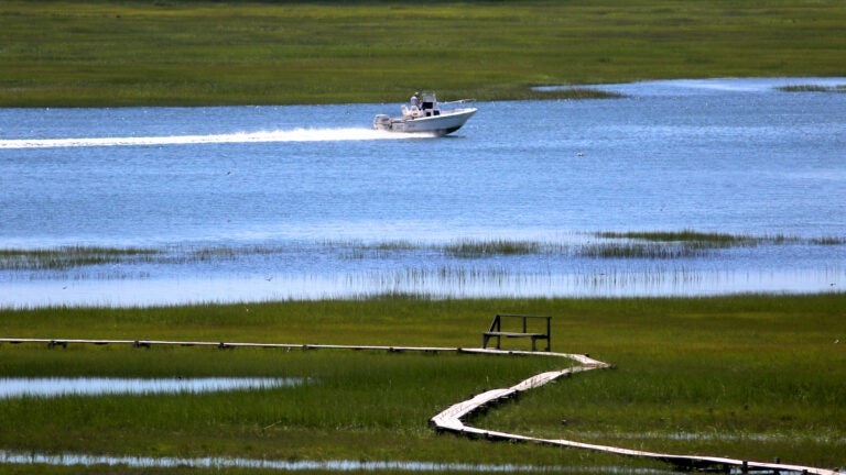 A pleasure boat speeds through the Great Marsh in Ipswich.
