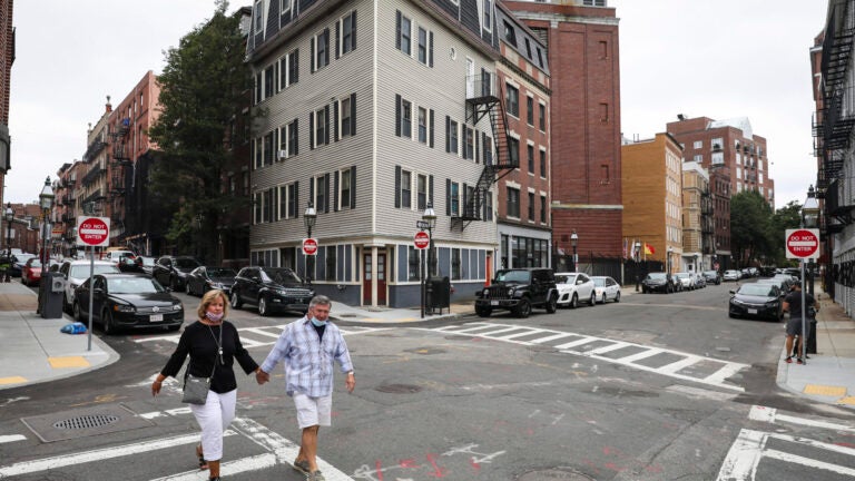 A couple walks in Boston's North End.