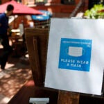 A sign outside of a host stand