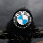 The company logo on the hood of an unsold 2020 5-series sedan