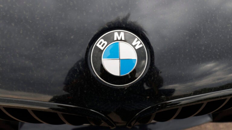 The company logo on the hood of an unsold 2020 5-series sedan