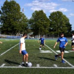 Braintree High Schools' soccer coach oversees team tryouts.