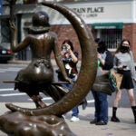 Visitors at the Samantha statue in Salem.