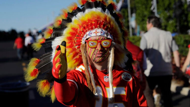 A Kansas City Chiefs fan walks outside the stadium before Super Bowl 54.
