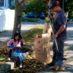 A father and daughter rake leaves in Quincy.