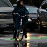 A soggy cyclist in Coolidge Corner.