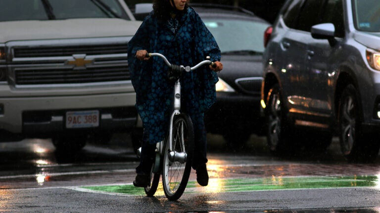 A soggy cyclist in Coolidge Corner.