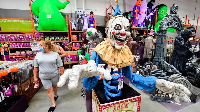 People shop for Halloween items at a home improvement retail store.