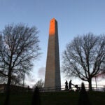 People stroll around the Bunker Hill Monument.