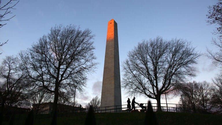 People stroll around the Bunker Hill Monument.