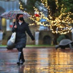A woman walked past a lit Christmas tree in Copley Square.