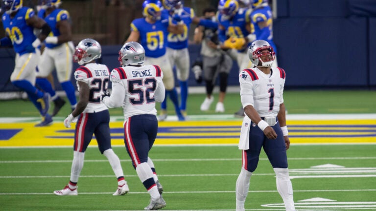 Cam Newton of the New England Patriots throws the ball in the second